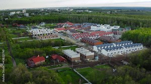 Neighborhood concept. Building a cottage town: variety of cottages and duplexes surrounded by nature - established shot. Construction of suburban eco-friendly housing.