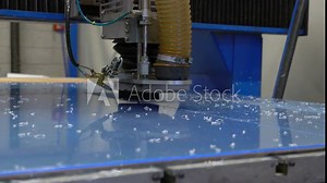 Cnc milling cutter cuts sheet of plastic on robotized production line. Factory robots used to produce precise an strict product on automation conveyor lines.