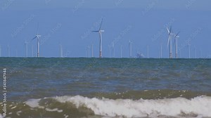 Wind turbines producing power in the UK landscape