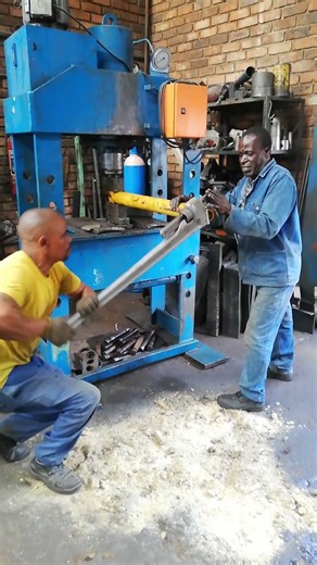 USING MONKEY HAND WITH LONG LEVER TO ADD POWER AND UNSCREW STUCK NUT I. REPAIRING DAMAGED PISTON