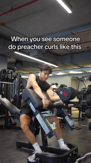 Tyler Pathradecha on Instagram: "One of the best tips on dumbbell preacher curl is to use your off hand to pull yourself into the preacher curl rest for more stability. #fitness #gym"