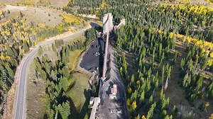 Aerial coal mine transfer mountain autumn Utah climb. Extracting coal from ground. Tunneling, digging, deep underground. Environmental impacts, pollution, global warming, climate change energy use.