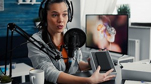 Premium Photo | Tech enthusiast doing unboxing review video of modern smartphone while presenting specifications to audience. content creator unpacking touchscreen mobile phone while doing recommendation video.