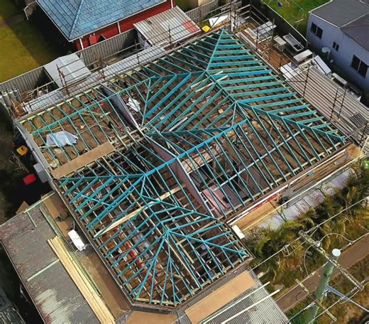 Nexus Built | Newcastle Builder on Instagram: "Stick-built roof framing. No prefab trusses here. Intersecting hips, valleys, gables, and dutch gables make up a roof with multiple planes and pitches, each one calculated and laid out by hand. No templates. No pre-cut packs. Just carpenters who know their tools and understand geometry in real time. The structure had fire damage, so we worked to existing walls and irregular spans. Tight access, varied pitches, and complex junctions meant every rafte