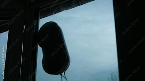 Automatic robot window cleaner. The robot vacuum cleaner cleans the outside of the window.