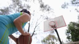 Mature woman playing basketball