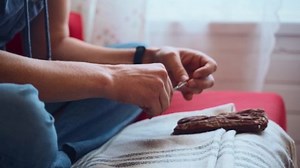 clip-1088825951-close-young-man-cutting-his-toenails-living