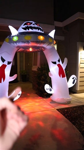 If you're looking to have the coolest house on the block this Halloween, this giant inflatable UFO arch is the way to do it. It's become the main centerpiece for my entire front yard display and looks absolutely amazing. ​The design features two huge ghosts holding up a UFO, creating a perfect walkway. I love the details on the UFO itself, especially its creepy glowing red eyes and the flashing multi-color lights that circle around it. It really stands out at night. ​My favorite part, though, is