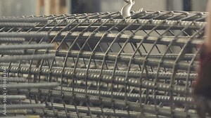 Stacked circular column reinforcement in preparation of heavy lifting in metalworking factory.