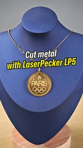 7.9K views · 42 reactions | Looking to cut metal and craft jewelry? Try it with the LP5! We made an Olympic commemorative necklace with ease using the LP5. ✨ Project details: Model: LaserPecker LP5 Material: 0.3mm brass Settings: 1064nm, 26 (laser frequency) / 100 (power) / 96 (depth) / 3 (pass) #laserpecker #laserpeckerlp5 #lp5 #metalcutitng #olympics2024 | LaserPecker Global | Facebook