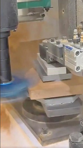 Automated milling machine precisely cuts the small piece of wood secured on the rotary table