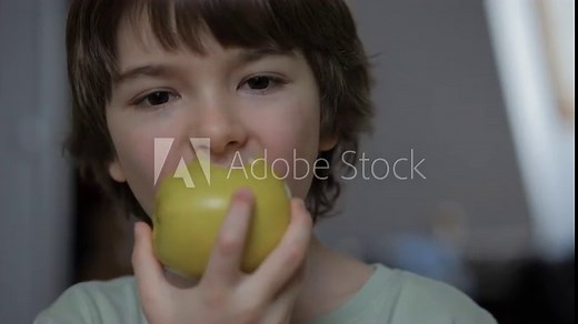 Portrait of Little Boy Eating Green Apple. Child Eats Fruit. Kid Bites Fruit and Chews Looking at Camera in Kitchen. Diet Vegetarian Healthy Nutrition Happy Child Biting Eating Apple. Stock Video