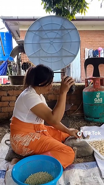 Husking Rice: Traditional Techniques in Outdoor Settings