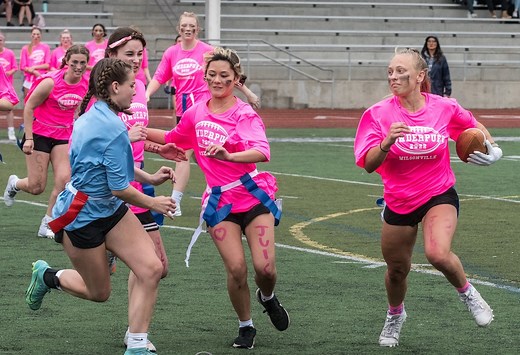 Powderpuff games give girls a chance to play football, but some wrestle with sexist undertones