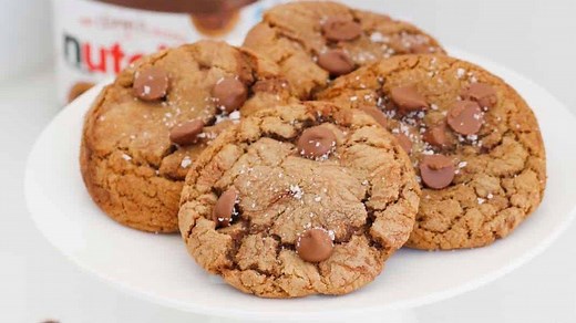 51K views · 107 reactions | Say hello to the most delicious Nutella Chocolate Chip Cookies EVER… soft and gooey on the inside, chewy on the outside, loaded with chocolate chips, sprinkled with sea salt and swirled with creamy Nutella. Get the recipe here: https://bakeplaysmile.com/nutella-chocolate-chip-cookies/ | Bake Play Smile | Facebook