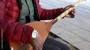 Man playing Turkish musical instrument baglama. Baglama is the most commonly used string folk instrument in Turkey