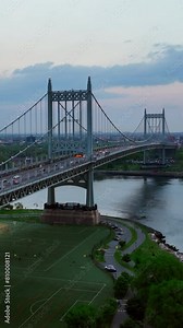 Several football pitches locating under Triborough Bridge in New York. Hell Gate Bridge at backdrop. Vertical video