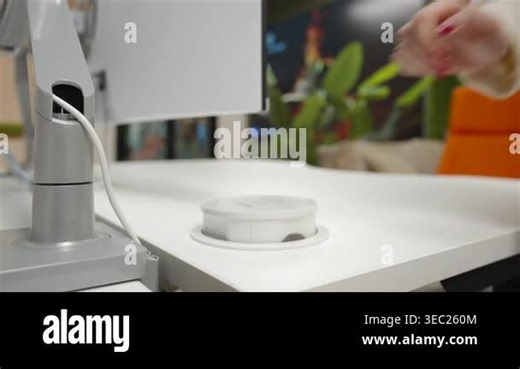 White Desk Recessed Power Hub Charging Undermonitor Cable Management With Plant And Orange Chair In Background. Creative Stock Video Footage - Alamy