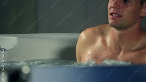 young, romantic couple in jacuzzi spending romatic time together