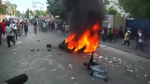 A cancelled election, violence in the streets and an opposition government who refuse to take part in the ballot. Protests in Haiti as their democratic process faces challenges. | Channel 4 News
