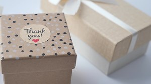 a thank you sticker on a gift box