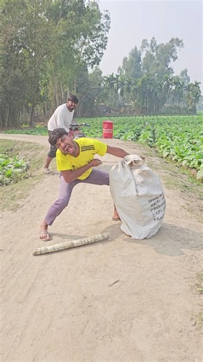 A man is sitting on the side os the road with a packet