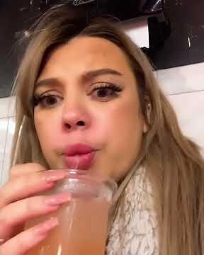 Girl is drinking in bar bathroom after the bar closed.