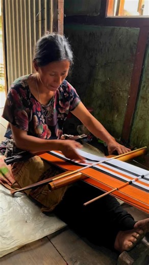 Vidya Lakshmi on Instagram: "Backstrap loom weaving is a prominent traditional weaving technique practiced by the Naga tribes in Kohima, Nagaland. This technique, using a loom where the weaver’s body provides the tension, has deep cultural significance in the region. The process itself is intricate and highly skill-intensive, as the weaver controls the tension and alignment by leaning back or adjusting their position. The weaving is typically done by women, with each pattern or colour carrying c