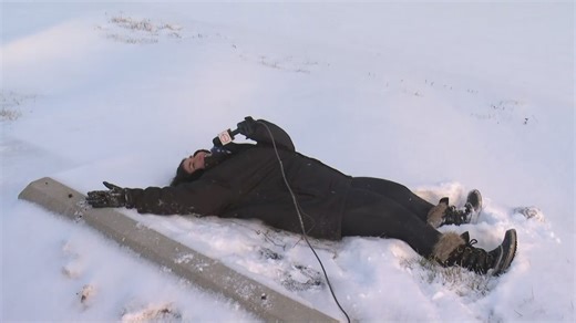 Snow angel, anyone? Kristen Mirand enjoys wintry fun during live report on 3News at 5
