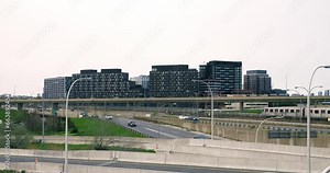 Cars moving on freeway at USA city. Wide view of busy USA city with lots of cars on freeway, moving subway train, skyscrapers in downtown. Concept use freeway traffic junction at rush hours in USA
