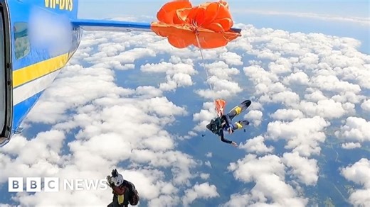 Moment skydiver's parachute wraps around plane
