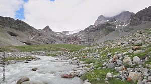 Alps landscape in the summer season, the rushing river with Piz Argient and Piz Zupò on background (Bernina massif)