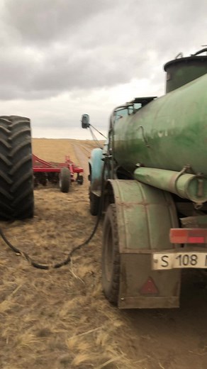 Large Red Tractor in Action on Rural Farm