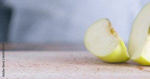 Close-up, man cuts off a slice of apple with a knife, camera circular motion