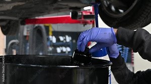 Mechanic cleaning and rinsing oil filter of car, slow motion shot