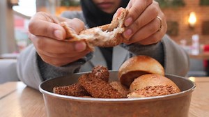 Download bread breaking on women hand for free