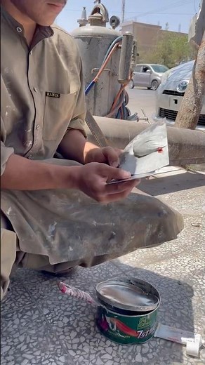 Applying putty to car door.