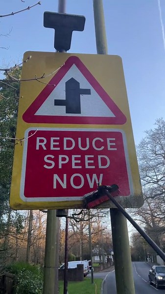 Person cleans a dirty road sign to look brand new again!