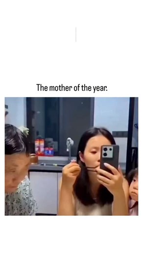 Lazy Legend on Instagram: "The video shows an Asian mother creatively punishing her teenage daughter by wrapping yellow duct tape around her head to secure her phone, enforcing a no-screens-during-dinner rule in a bustling kitchen setting with minimal family interruption. Posted on December 16, 2025, by @TheFigen_ , a musicology educator focused on uplifting content, it quickly amassed 17,500+ likes, tapping into viral trends of relatable parental ingenuity seen in platforms like. Replies mix am