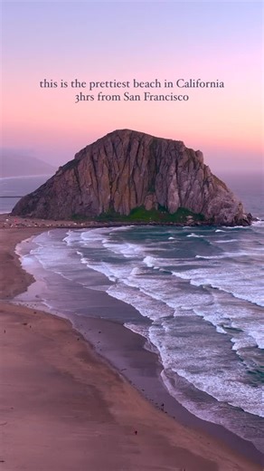 Nell Narasappa | California Travel & Outdoor Adventure on Instagram: "location details ⬇️⬇️ Can you see the couple in red and black, walking together in the first clip? This is the perfect place for beautiful sunsets this time of year! It even comes with a massive rock of solidified magma that you can gawk at while the soaring falcons steal the spotlight 🙃 📍Morro Rock, California Located in Morro Bay, near San Luis Obispo 💜 *NOT to be confused with Moro Rock at Sequioa Na