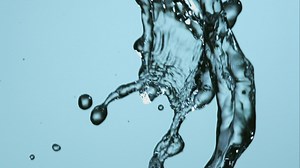 Water falling and a blue background - Free Stock Video