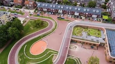 17K views · 815 reactions | Utrecht’s Dafne Schippers Bridge follows in the Dutch tradition of working together to find space-efficient design solutions. An elementary school acts as the on-ramp to a newly-built bike crossing of the Rijn Canal, complete with cycle path on the roof! https://vimeo.com/292657475 | Dutch Cycling Embassy | Facebook