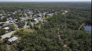 fast spin aerial from the marsh lands of the Weeki Wachee River to the Weeki Wachee Gardens subdivision that has access to it