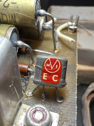 Hidden inside this tiny mid‑1950s circuit board are two of the rarest early solid‑state devices you’ll ever see: a pair of Marvelco J‑3 germanium transistors, each stamped with that distinctive red‑oval “J‑3” marking. Marvelco was a short‑lived, almost forgotten manufacturer operating during the earliest days of the transistor revolution. Their devices were hand‑assembled alloy‑junction germanium PNP transistors, built in small batches and used in experimental gear, intercoms, and early transist
