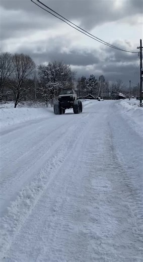 Four-Wheel Drive Vehicle Navigating Snowy Terrain