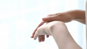 clip-34694194-woman-applying-cream-alcohol-based-sanitizer-on-other