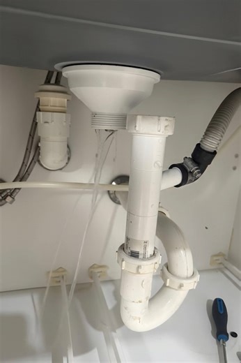 1.2K views | This under-sink view shows a partially assembled waste and water supply system with a garbage disposal. The black discharge elbow from the disposal connects to a white PVC trap adapter ready for the P-trap installation. The blue and red PEX lines represent cold and hot water supplies with shutoff valves featuring lever handles.#fblifestyle #PlumbingGallery | Plumbing Gallery | Facebook