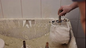 Prosthetic Design, Prosthesis Production, Molded Prosthetic. In process of forming prosthetic leg mold for hip disarticulation, man diligently packs in gypsum solution.