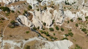Aerial View of Goreme valley in Turkey. Panorama of Cappadocia - wide angel landscape mountain peaks of ancient cave town Uchisar.