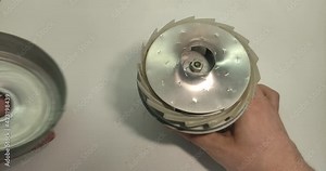 Service center foreman repairs the electric motor of the vacuum cleaner